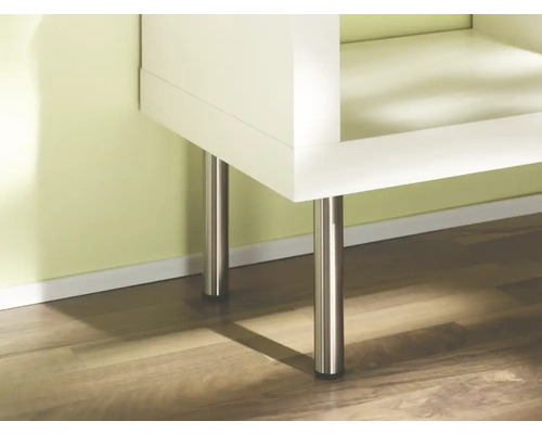 Detailopname van een witte kast met metalen poten op een houten vloer