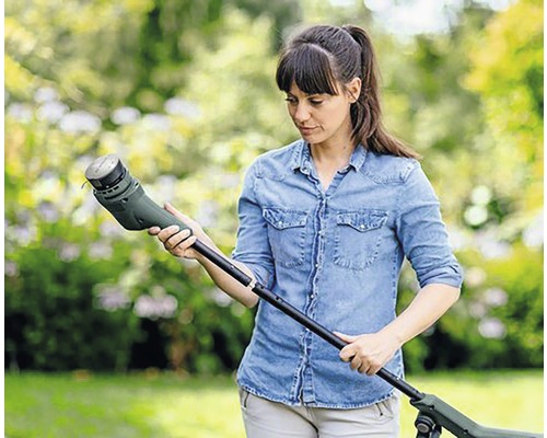 Vrouw monteert gazontrimmer in de tuin