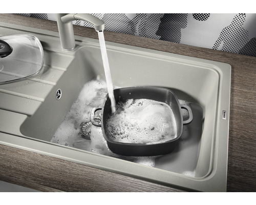 Spoelbak met kraan en pan tijdens het afwassen