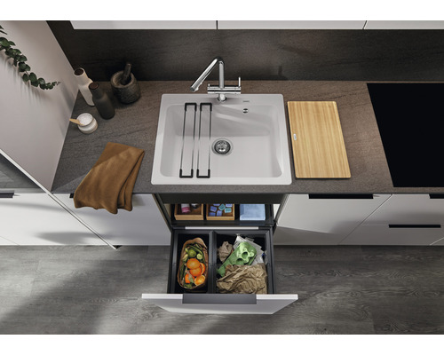 Keuken spoelbak met kraan, snijplank en afvalscheidingssysteem in een moderne keuken