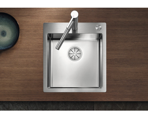 Roestvrijstalen spoelbak met kraan op houten aanrechtblad