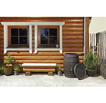 Houten gevel met ramen, bank, regentonnen en planten