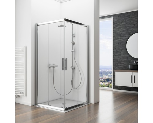 Hoekdouche met glazen deuren en douchegarnituur in een badkamer met wastafelonderkast en spiegel.