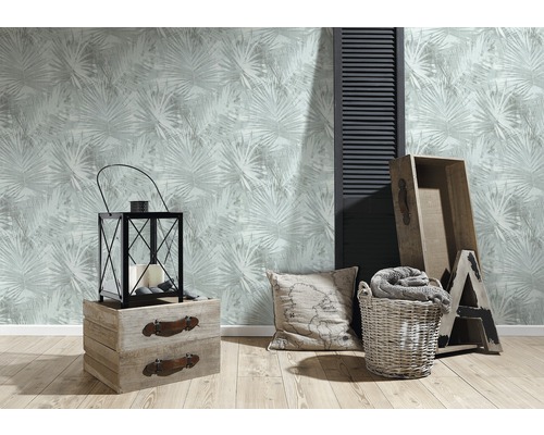 Woonkamer met patroonbehang, lantaarn, houten kisten, kussen en wasmand voor een gezellige sfeer