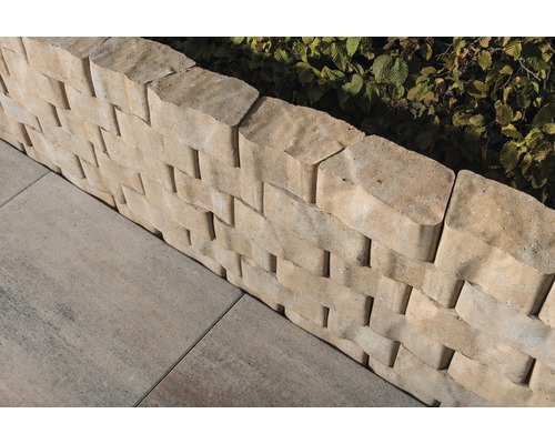 Detailaanzicht van een stapelmuur van betonstenen met straatstenen in de tuin