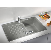 Spoelbak van steen met afdruiprek en kraan