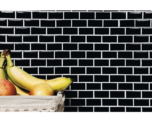 Wand met zwarte rechthoekige tegels en fruitmand