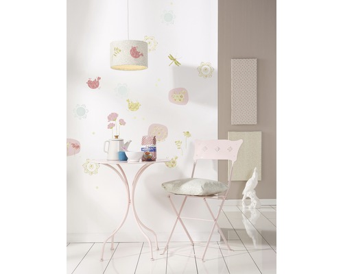 Kamer met tafel, stoel, lamp en wanddecoraties voor kinderen.