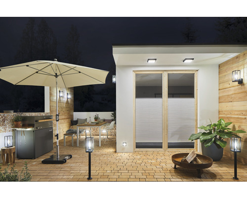 Terras met parasol, barbecue, tuintafel, zitplaatsen, vuurplaats en verlichting.