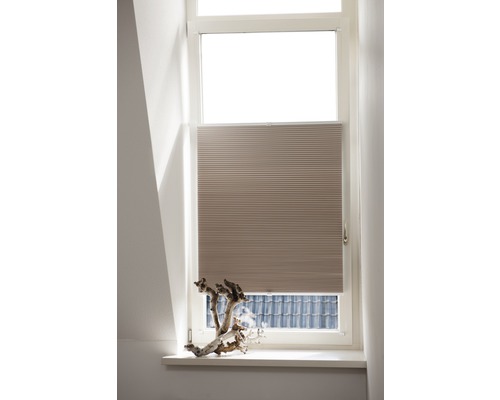 Beige plisségordijn voor het raam voor zonwering en decoratie