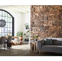 Woonkamer met decoratieve wandbekleding van kurk, bank en eettafel