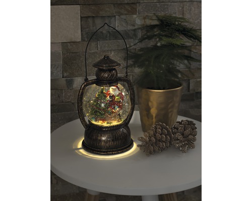 Decoratieve sneeuwbollantaarn met kerstmotief en verlichting.