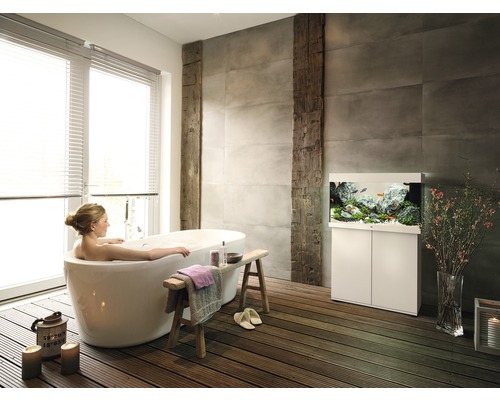 Lichte badkamer met vrijstaand bad, houten vloer en aquarium