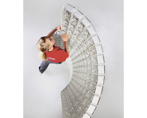 Vrouw installeert glazen bouwsteenmuur