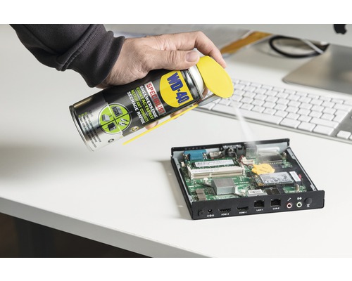 Een spuitbus contactspray van WD-40 wordt op een printplaat gespoten.