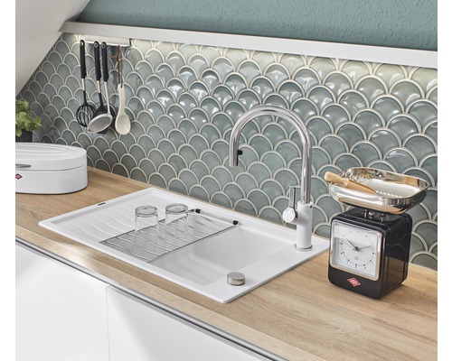 Keukenscène met gootsteen, kraan, vaatwerk en keukenweegschaal