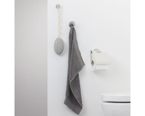 Badkamer aanzicht met handdoek, toiletpapierhouder en decoratie