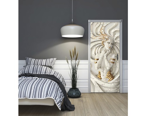 Slaapkamer met bed en deurposter van een vrouwensculptuur met gouden accenten.
