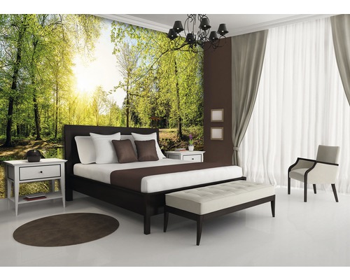 Lichte slaapkamer met bosbehang, bed, nachtkastje en stoel