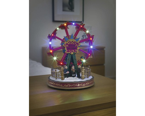 Verlichte, bewegende reuzenrad als kerstversiering met figuren.