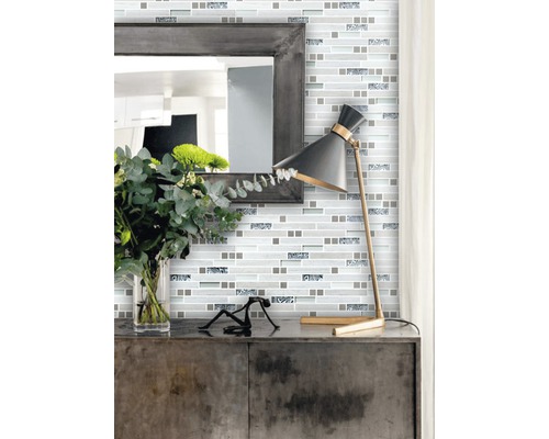 Wanddecoratie met mozaïektegels in moderne stijl met spiegel en lamp op een kast.