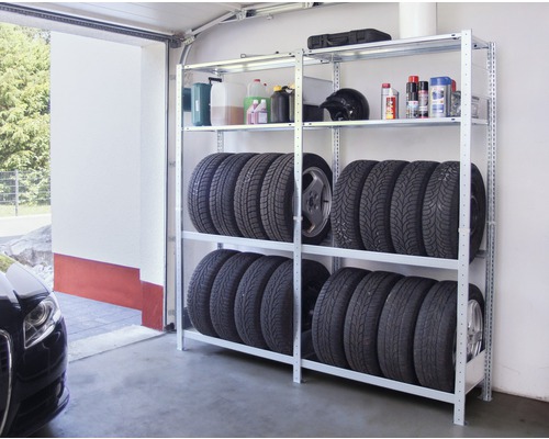 Rek systeem met autobanden en diverse containers in een garage