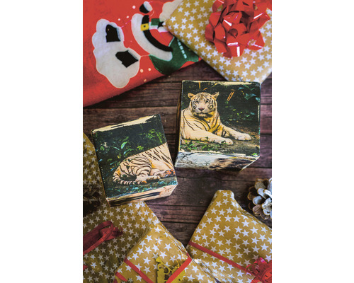 Decoratieve houten blokken met afbeeldingen van tijgers en kerstpapier op een houten tafel