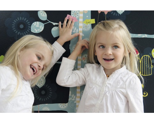 Twee kinderen bij een groeigrafiek voor een bloemenbehang