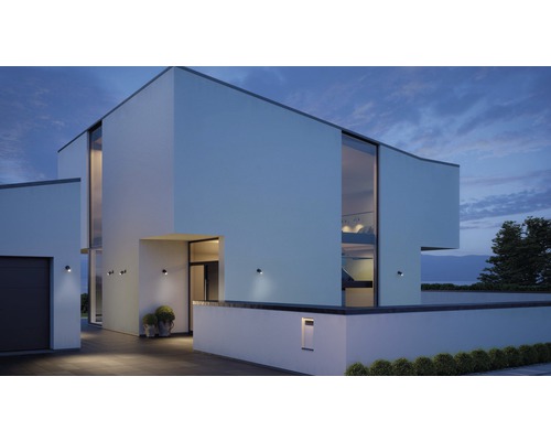Modern huis met buitenverlichting en grote ramen in de schemering