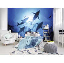 Slaapkamer met fotobehang dat een groep walvissen in de oceaan voorstelt