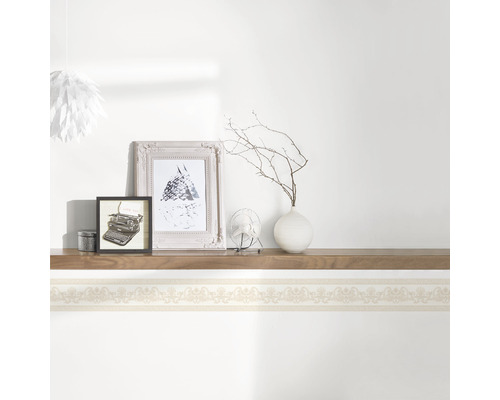 Decoratieve wandplank versierd met ornamenten, met decoratieve items erboven.