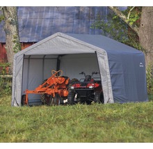 Grijze gereedschapsopslag met tractor en quad
