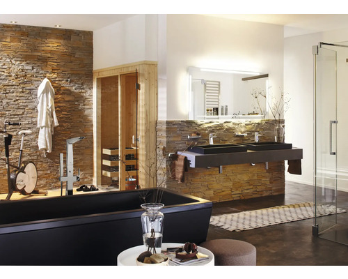 Lichte badkamer met ligbad, dubbele wastafel, sauna en hometrainer