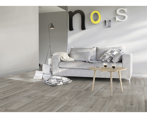 Woonkamer met grijze bank, houten tafel en laminaatvloer