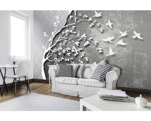 Woonkamer met foto wallpaper met boom en vogels voorstelling
