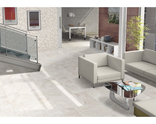 Lichte ruimte met vloertegels, trap, zithoek en decoraties voor een moderne woonsfeer.