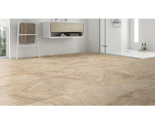 Badkamer met vloertegels, wastafel en douche.