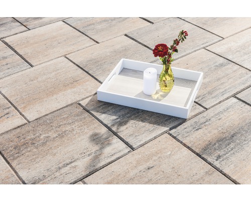 Betonklinkers op terras met dienblad, bloemenvaas en kaars