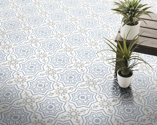 Tegelvloer met geometrisch patroon en potplanten op een houten tafel