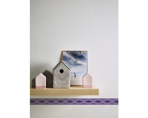 Decoratieve miniatuurhuizen en een afbeelding op een plank.