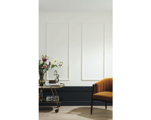 Woonkamer met wandpanelen, sierlijsten, serveerwagen en fauteuil