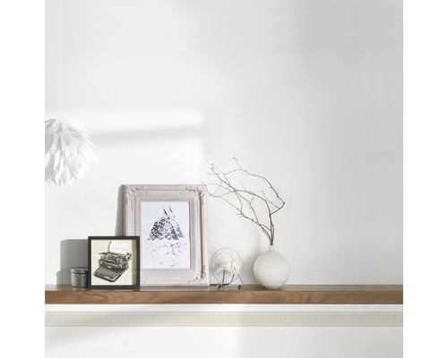 Decoratieve border in de kamer met fotolijsten, vaas en lamp.