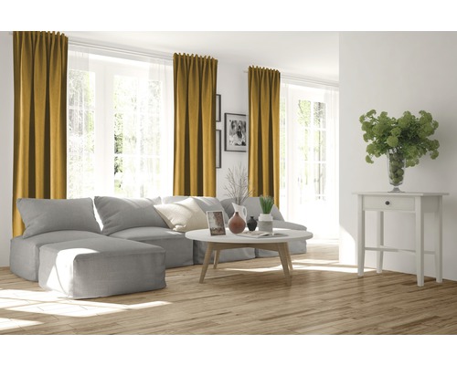 Woonkamer met grijze bank, salontafel, bijzettafel en gordijnen