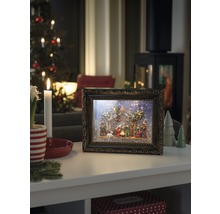 Decoratieve kerststal in fotolijst met kerstscène op een tafel