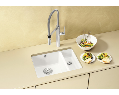 Keuken spoelbak met kraan en saladebereiding op het aanrecht