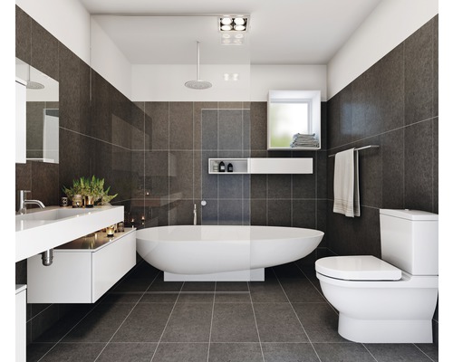 Moderne badkamer met ligbad, wastafel, toilet en grijze tegels