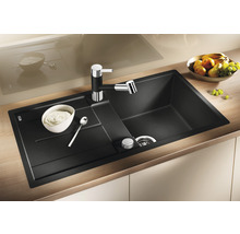 Granieten spoelbak met kraan en zeepdispenser op een aanrecht.