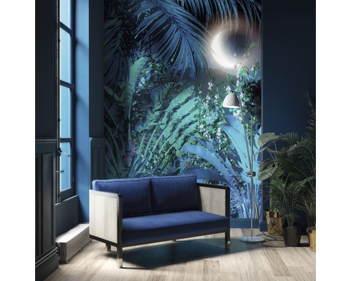 Woonkamer met blauwe bank, staande lamp en wandbekleding met jungle motief