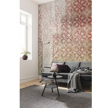 Woonkamer met patroonbehang, bank, salontafel en vloerkleed.