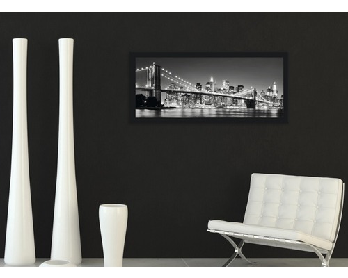 Decoratieve woonkamer met ingelijste afbeelding van een stadsgezicht, witte vazen en een fauteuil